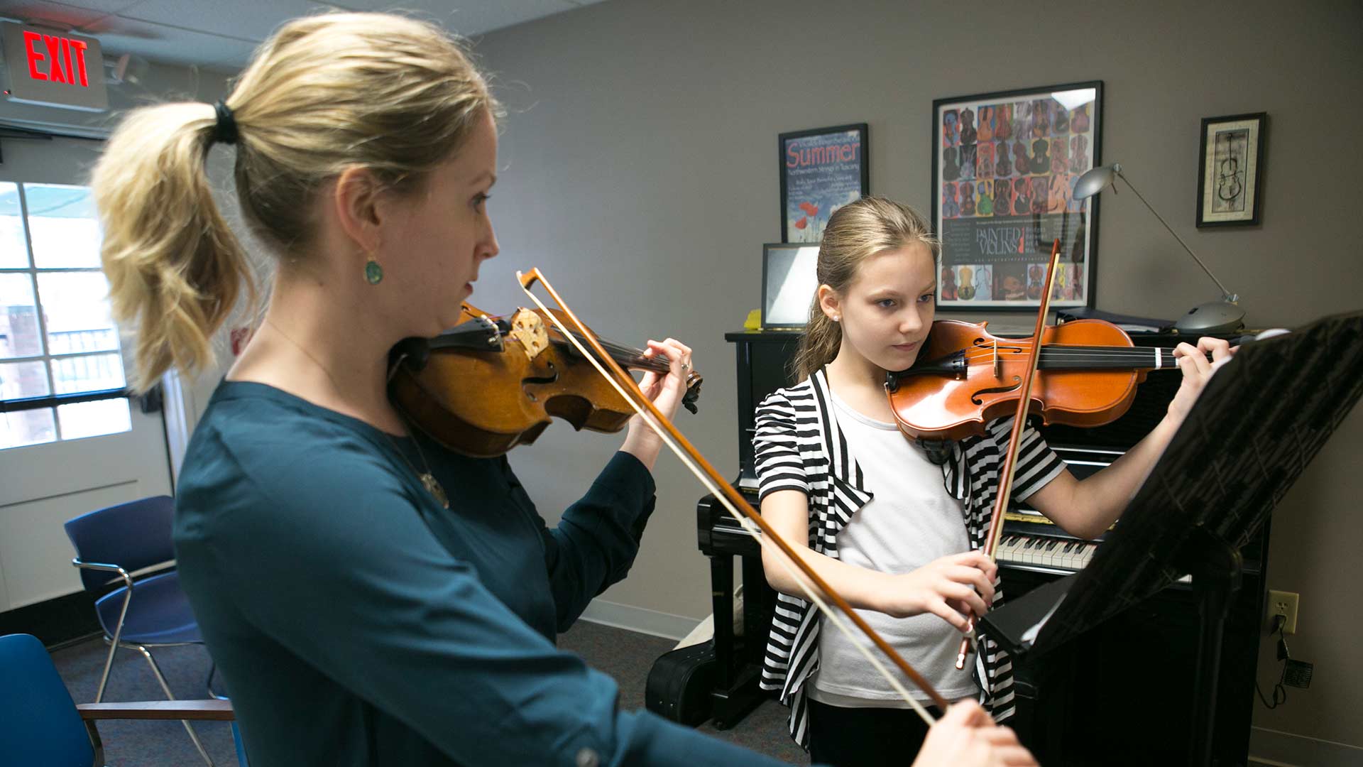 instructor teaching violin
