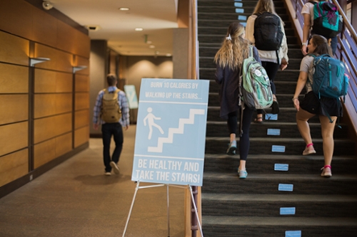 Students walk the stairs at the College of Health Sciences